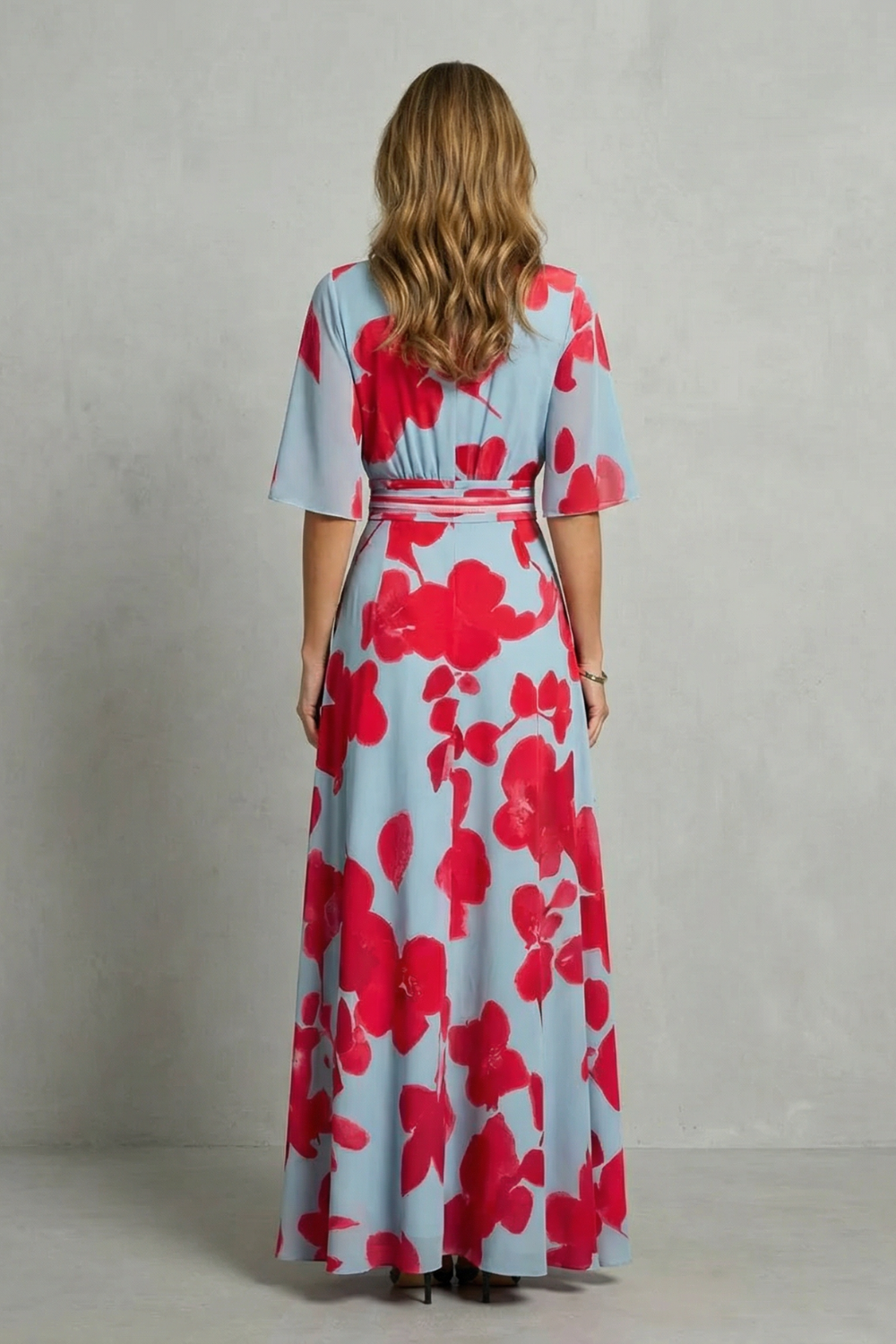 Back view of women's light blue and red floral maxi dress, showing defined waistband and full pattern