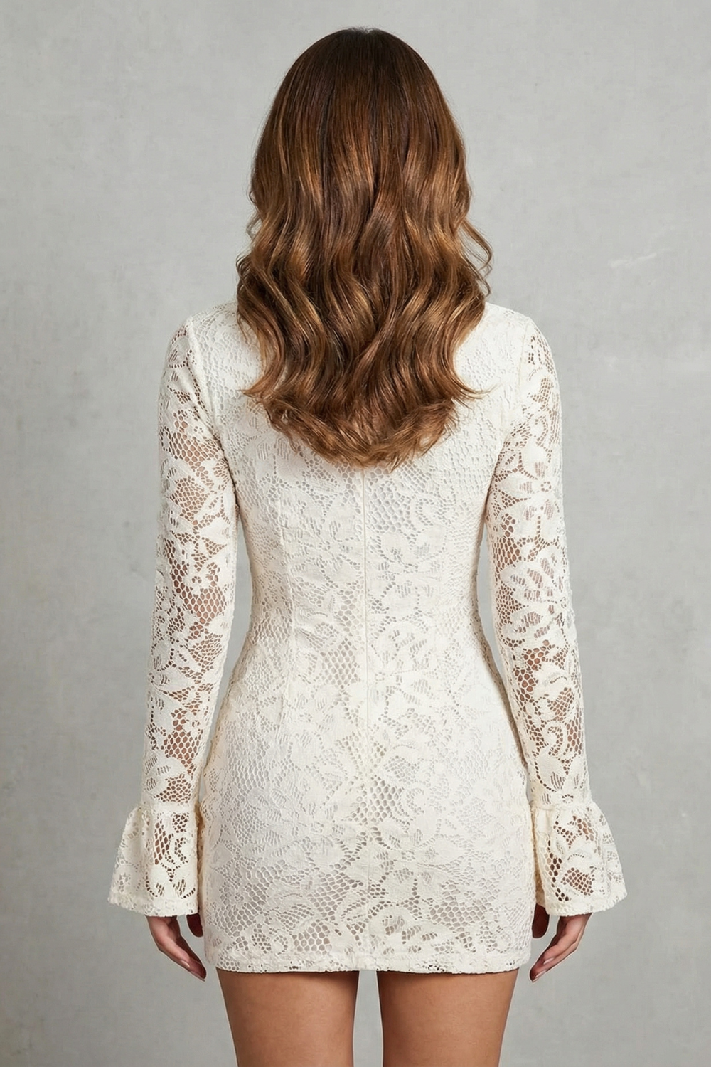 Back view of a women's elegant white lace mini dress with long sleeves and high neckline.