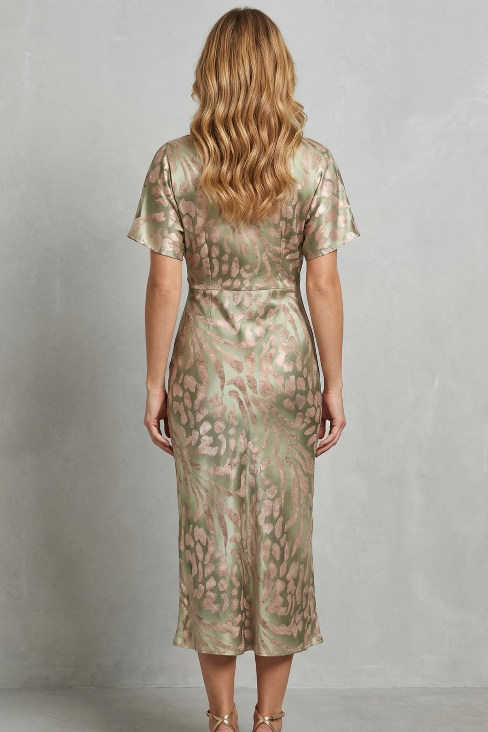 Back view of the women's green and pink printed V-neck short sleeve midi dress, showcasing the full pattern and midi length.