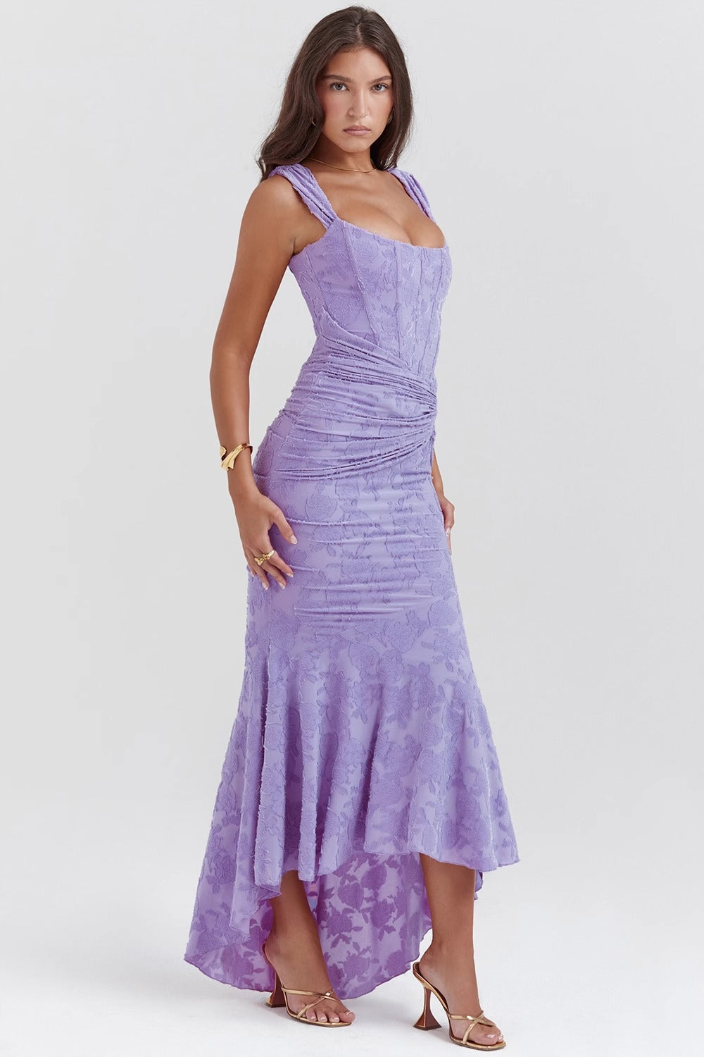 Side view of a women's elegant lavender floral lace midi dress, featuring a flattering bodycon silhouette and high-low hem.