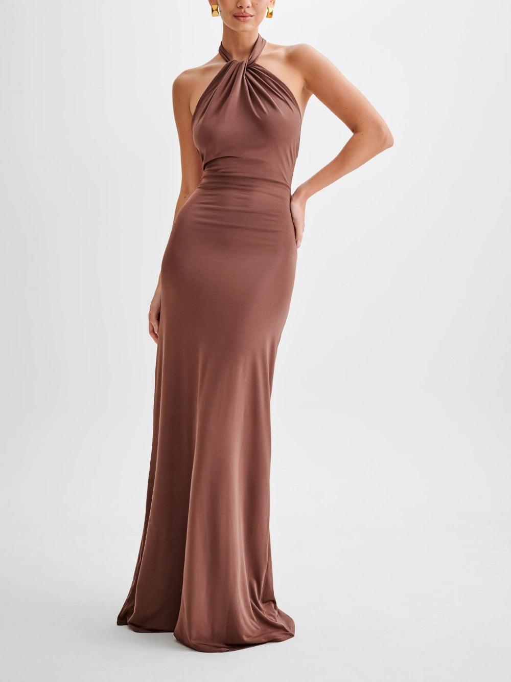 Chocolate brown halter neck ruched maxi dress, floor-length bodycon style, front view on white
