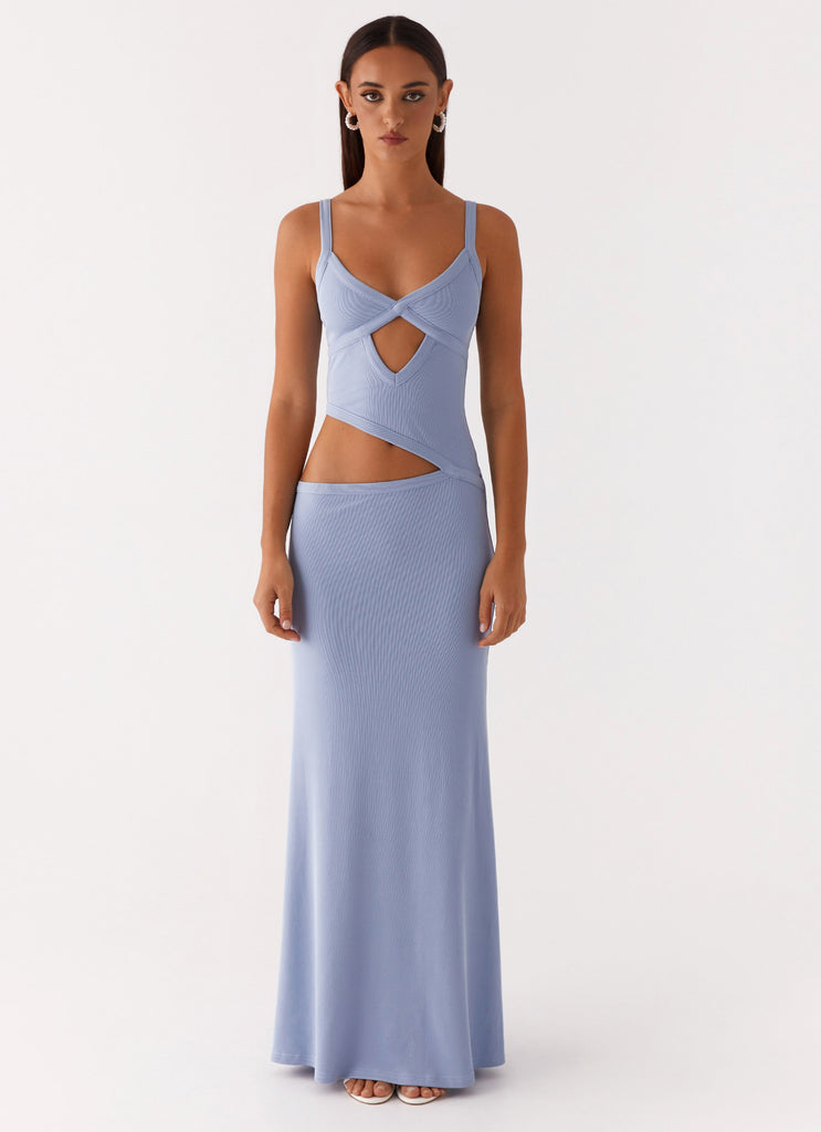 Front view of a women's bodycon maxi dress in light blue with a unique cut-out design at the waist and bust.