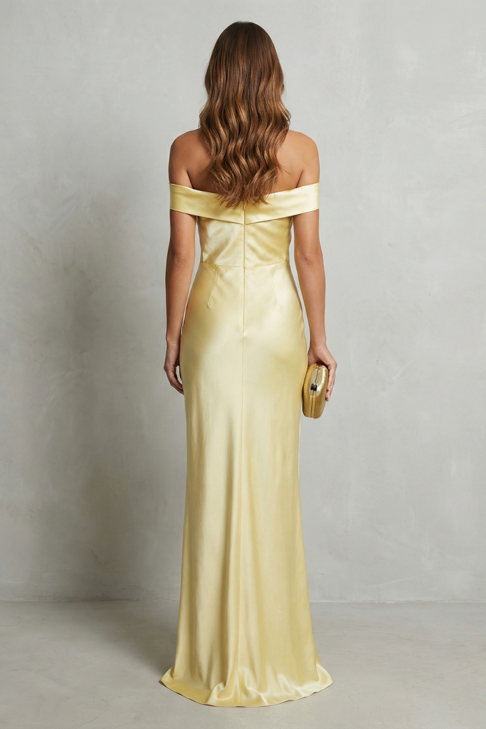 Back view of a yellow off-shoulder satin maxi dress, highlighting the straight back and floor-length design.