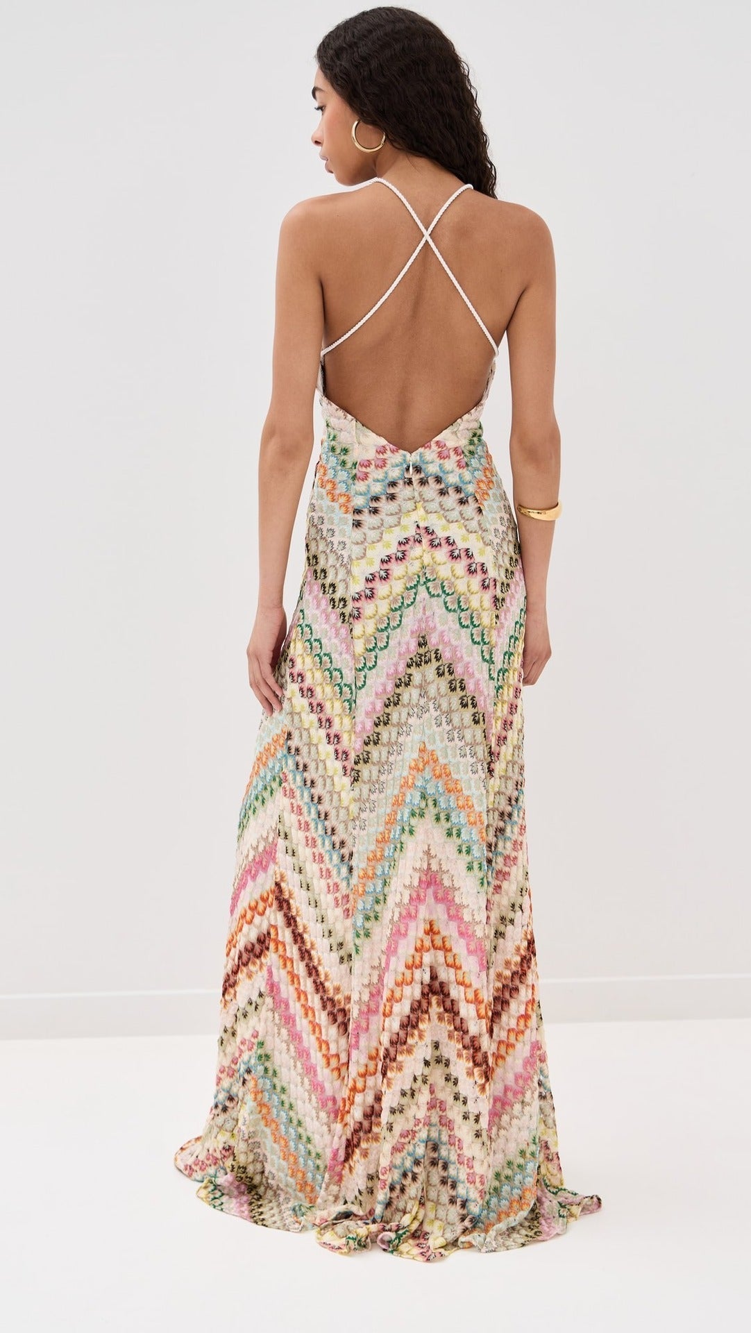Back view of a women's colorful chevron embroidered maxi dress featuring an open back and crisscross straps.