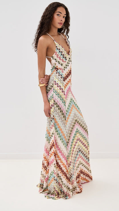Side view of a women's full-length chevron embroidered V-neck maxi dress, showcasing the flowing skirt and colorful design.
