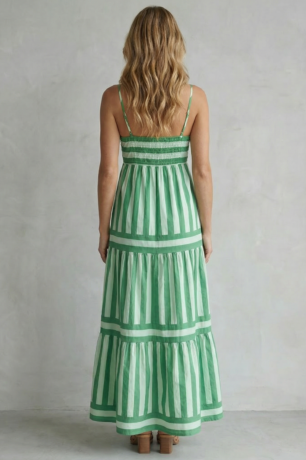 Back view of the green and white striped tiered maxi dress, showing the smocked detail on the back bodice.