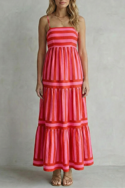Front view of a vibrant red and pink striped tiered maxi dress, a colorful option for a beach dress for women.