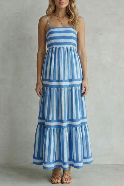 Front view of a blue and white striped tiered maxi dress with thin shoulder straps, a classic vacation outfit.