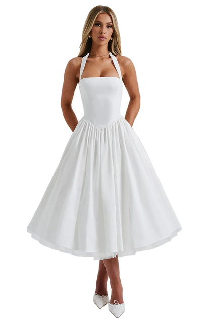 Front view of a white backless halter neck midi dress with a full pleated skirt and structured bodice, perfect for a baby shower.