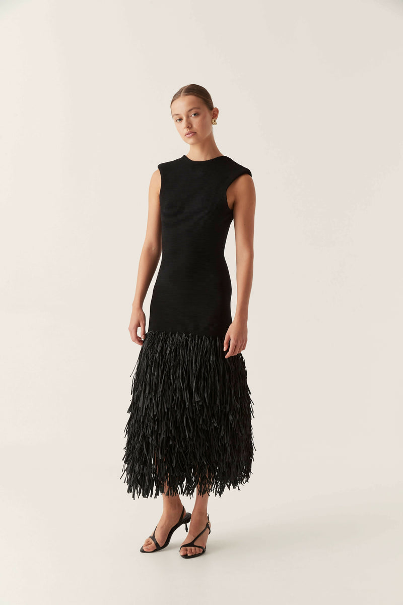 Elegant black bodycon maxi dress with a textured fringe skirt and scoop neck, perfect as a midi wedding guest dress.