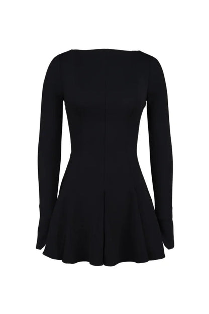 Model from behind wearing the Kouvr Fashion black long sleeve mini dress, showing the button details on the split cuffs