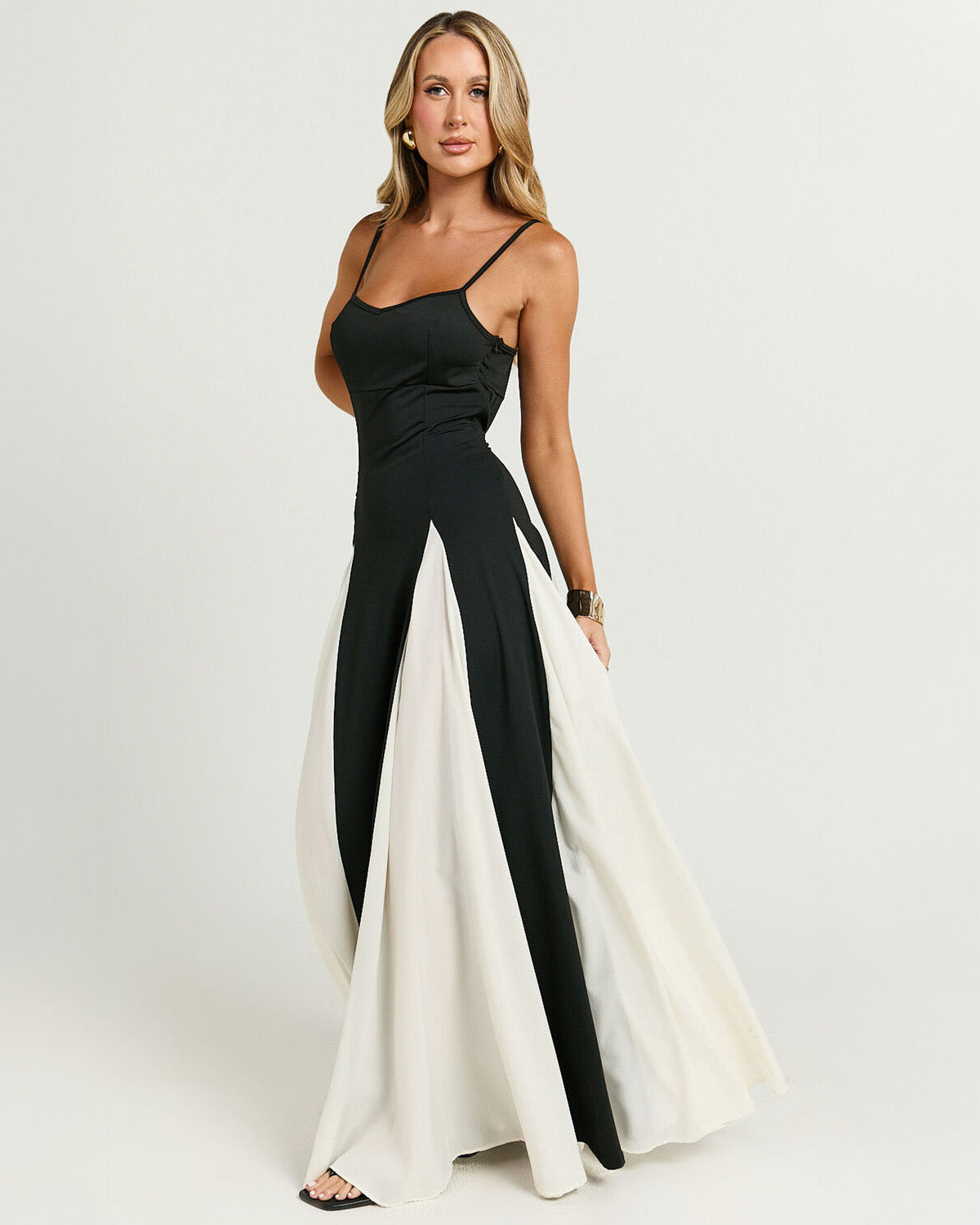 Side view of the women's black and white panel maxi dress, highlighting the dramatic floor-length skirt and the flattering silhouette, a stylish vacation dress option.