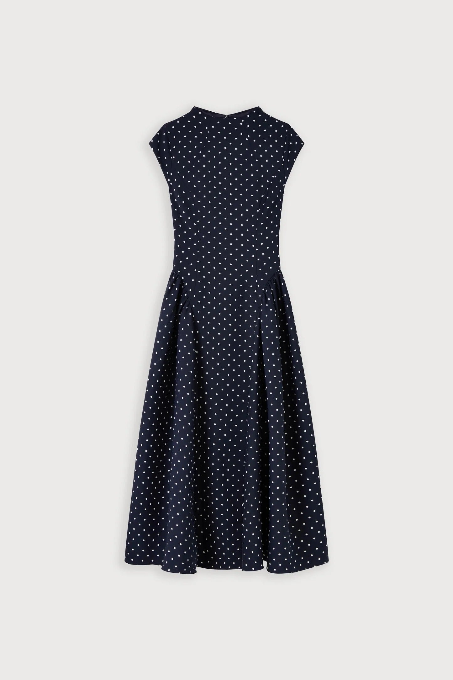 Front view of navy polka dot cap sleeve gathered midi dress with crew neckline and full skirt