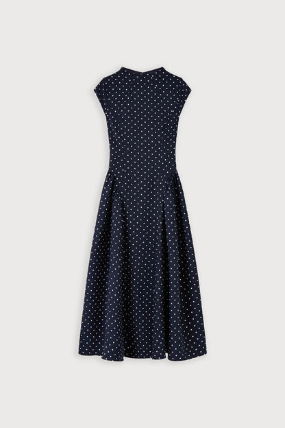 Front view of navy polka dot cap sleeve gathered midi dress with crew neckline and full skirt