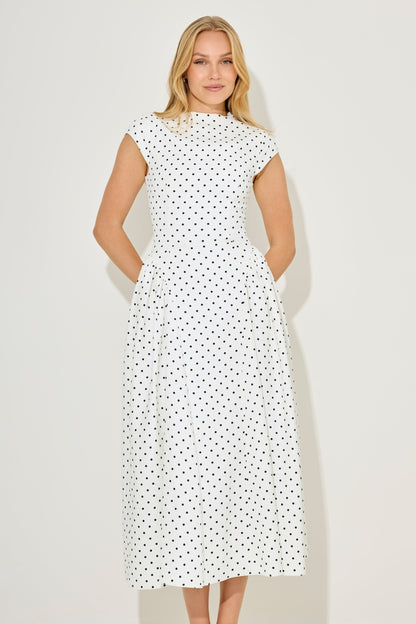 White polka dot gathered midi dress front detail with defined waist seams and cap sleeve silhouette