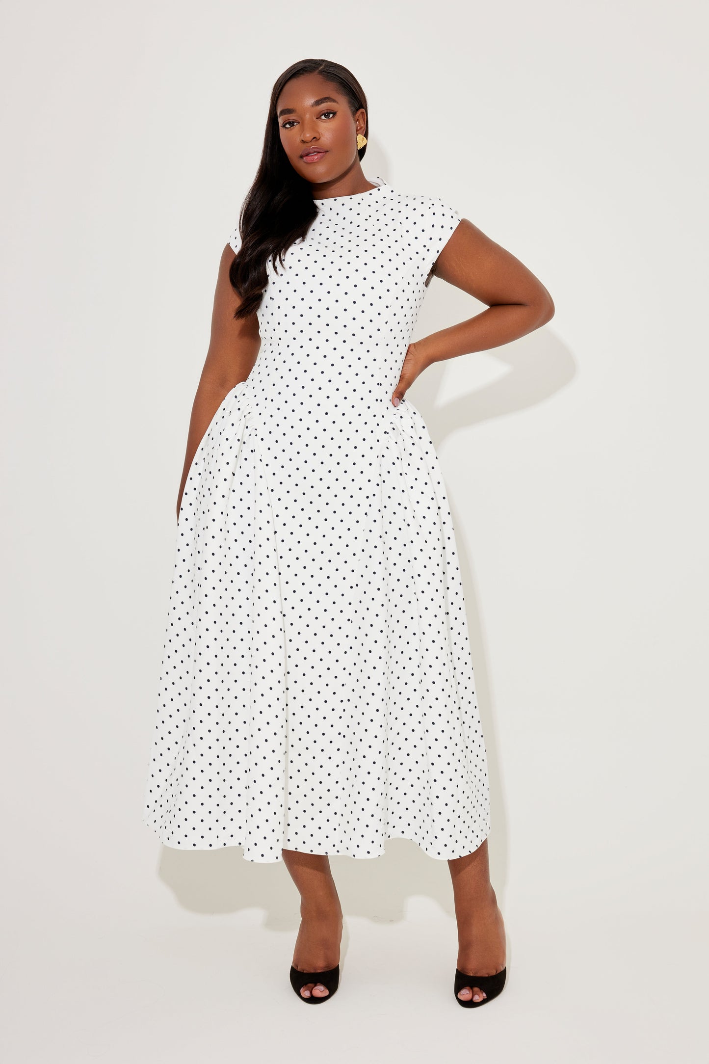 White with black polka dots cap sleeve gathered midi dress, fit-and-flare shape shown from front