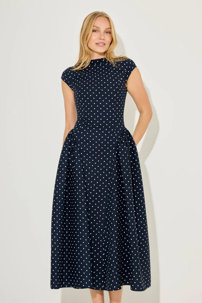 Navy polka dot cap sleeve gathered midi summer dress with high neckline and full skirt, front view