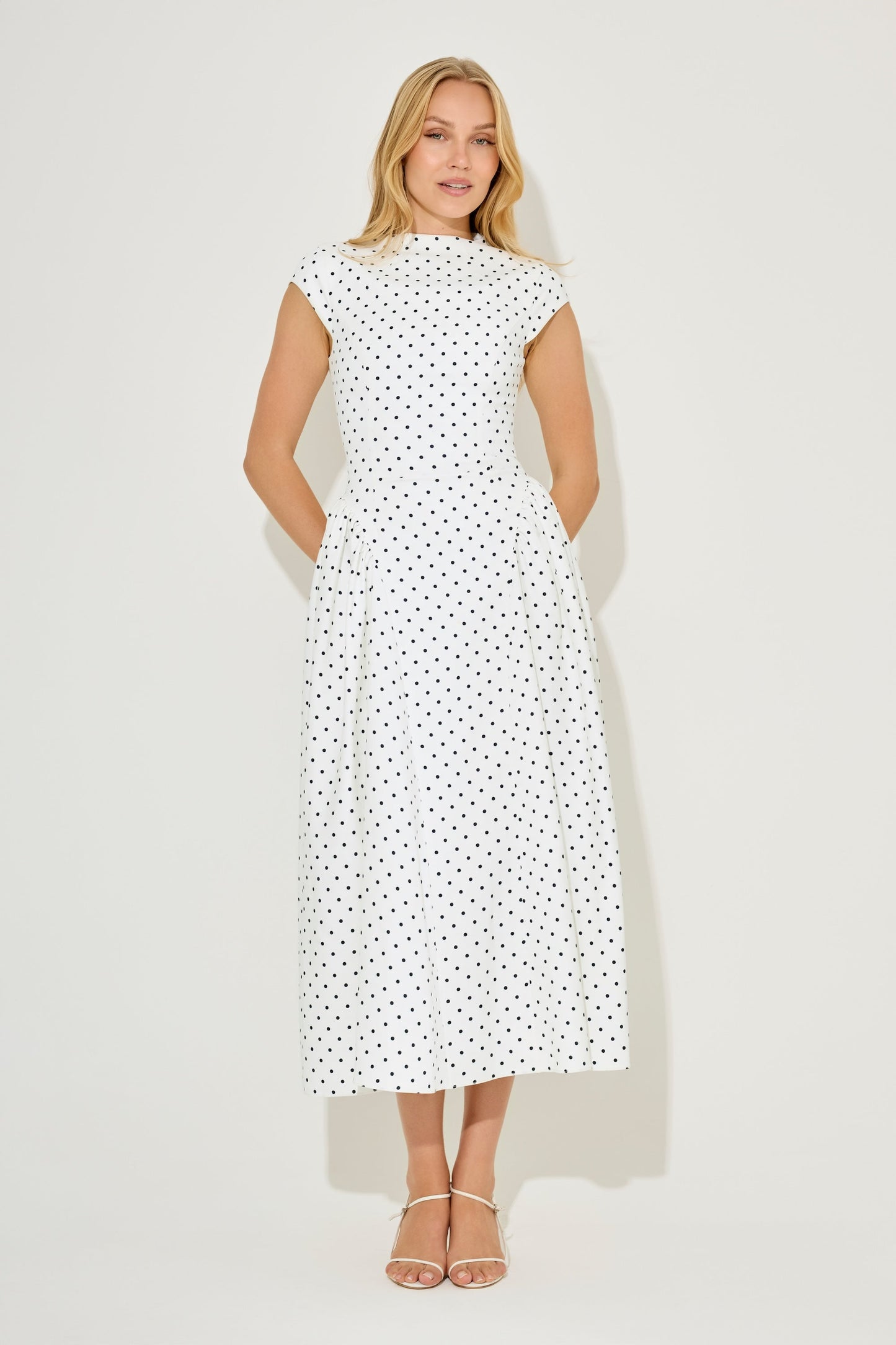 White polka dot cap sleeve gathered midi summer dress with high neck and flared skirt, front view