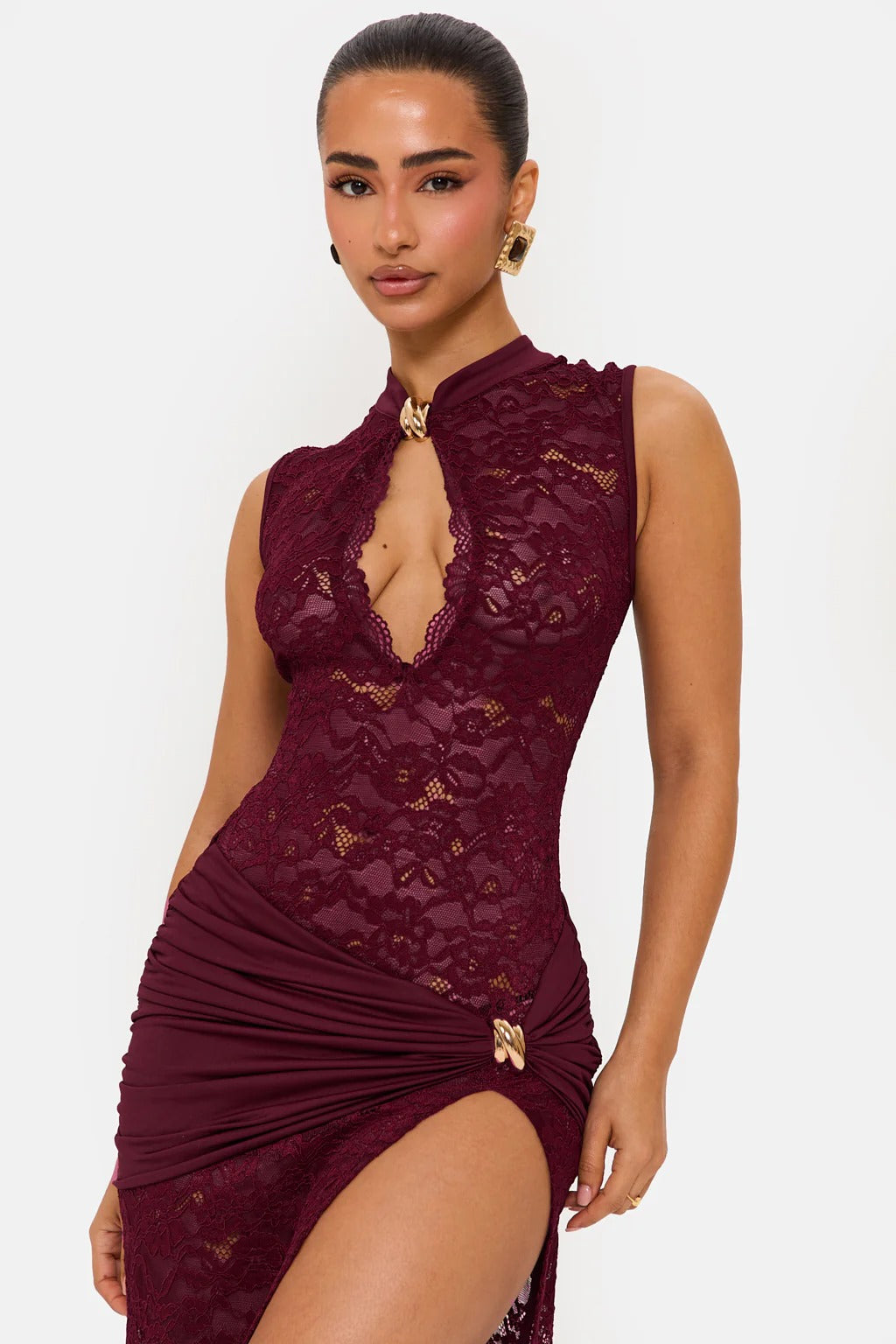 Close-up of a burgundy floral lace maxi dress, featuring the mock neck, keyhole cutout, and gold hardware on the ruched waist.