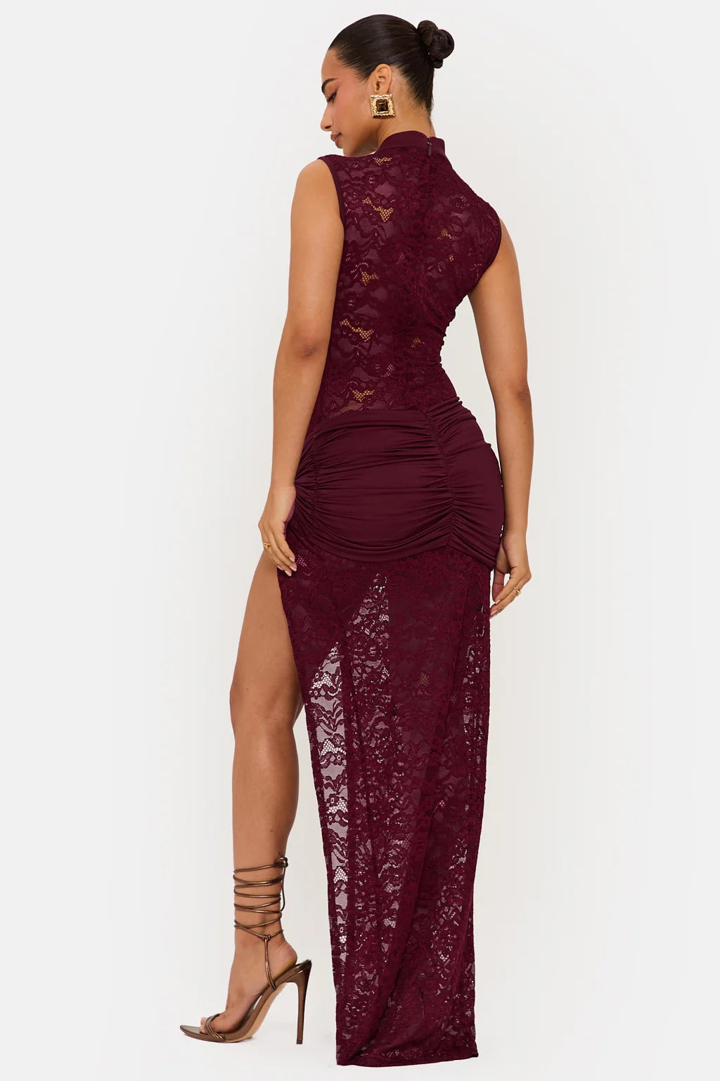 Back view of a burgundy floral lace maxi dress, showcasing the ruched detailing and the high slit, ideal for a cocktail event.