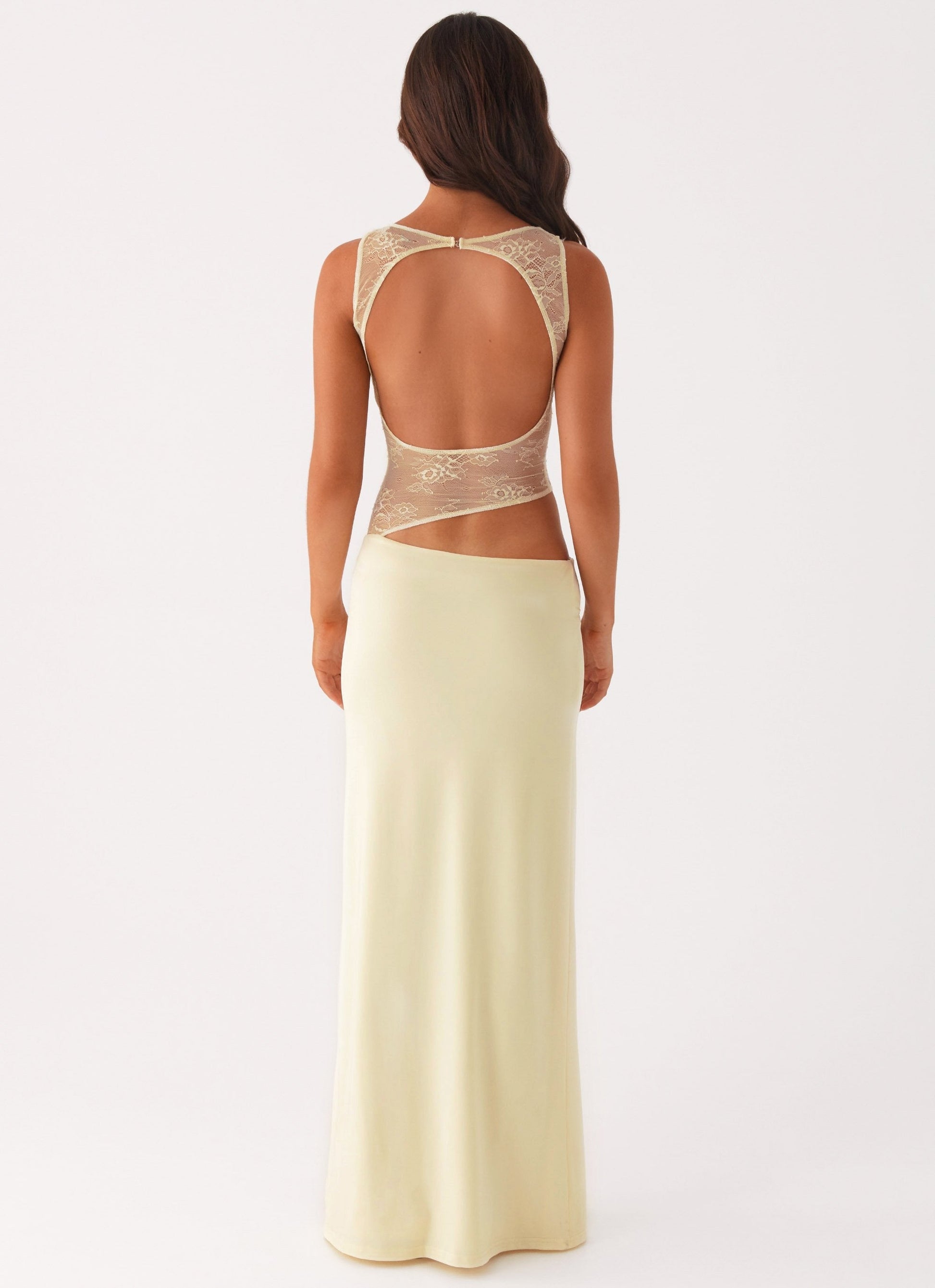 Back view cream maxi dress showing large open back cutout and sheer lace bodice detail