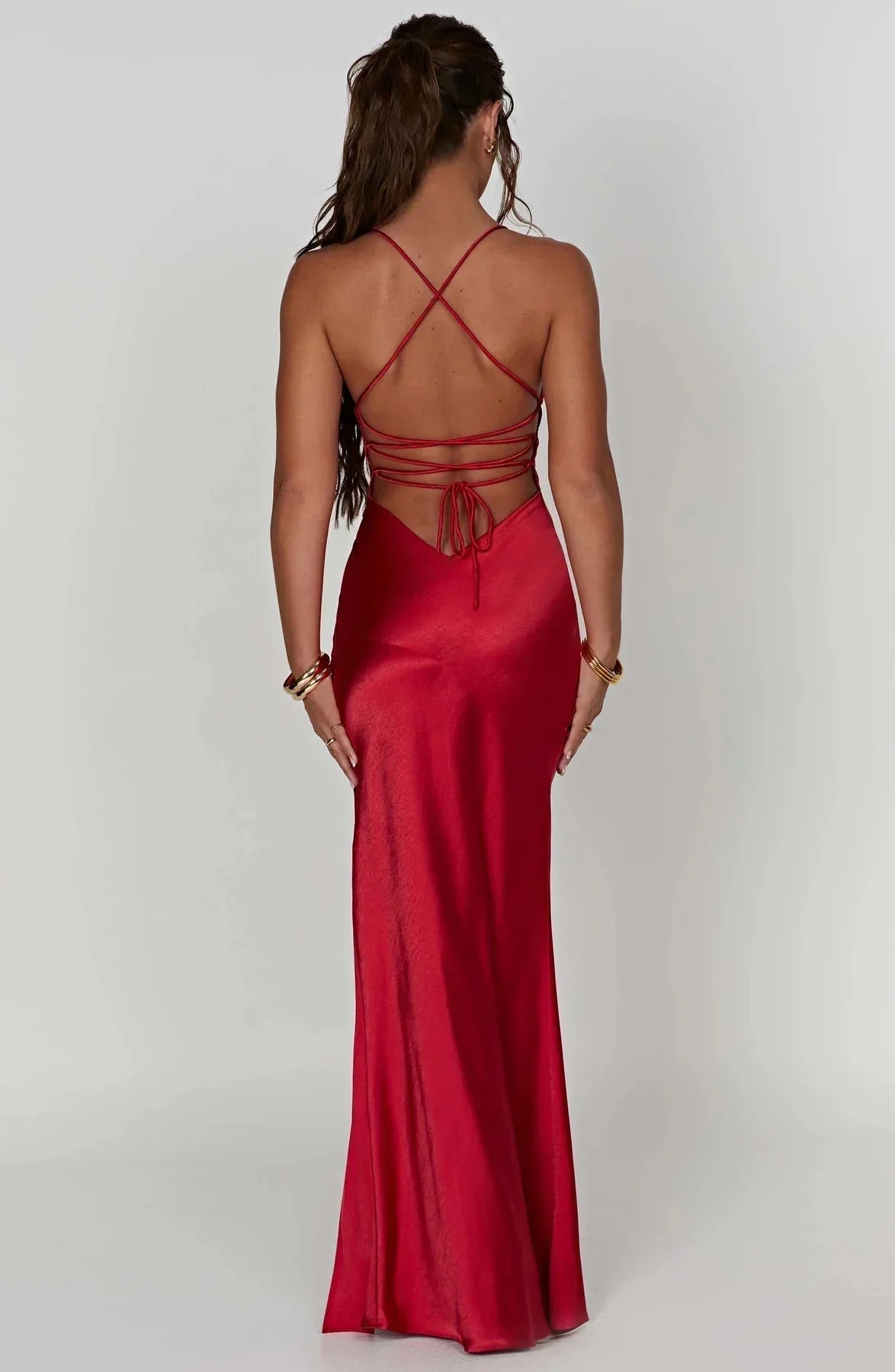 Back view of red satin maxi dress with crisscross straps and tie detail
