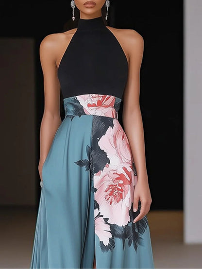 Close-up of black crew neck sleeveless maxi dress with floral waistband and teal A-line skirt