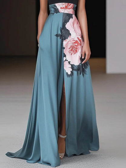 Teal A-line maxi dress skirt detail with pink floral print panel, high slit, and flowing hem