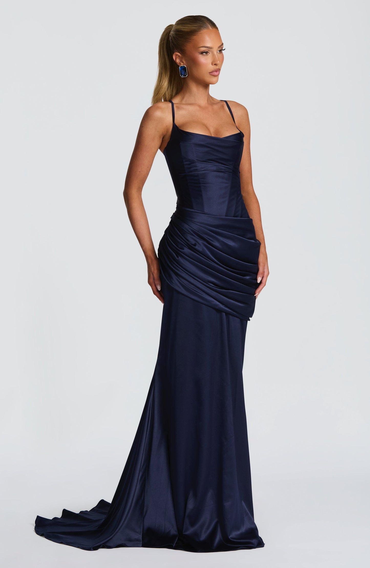 Side view navy satin bodycon maxi dress with corset bodice and gathered wrap detail at hips