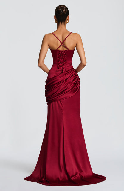 Back view burgundy satin maxi dress showing lace-up corset panel and crisscross straps