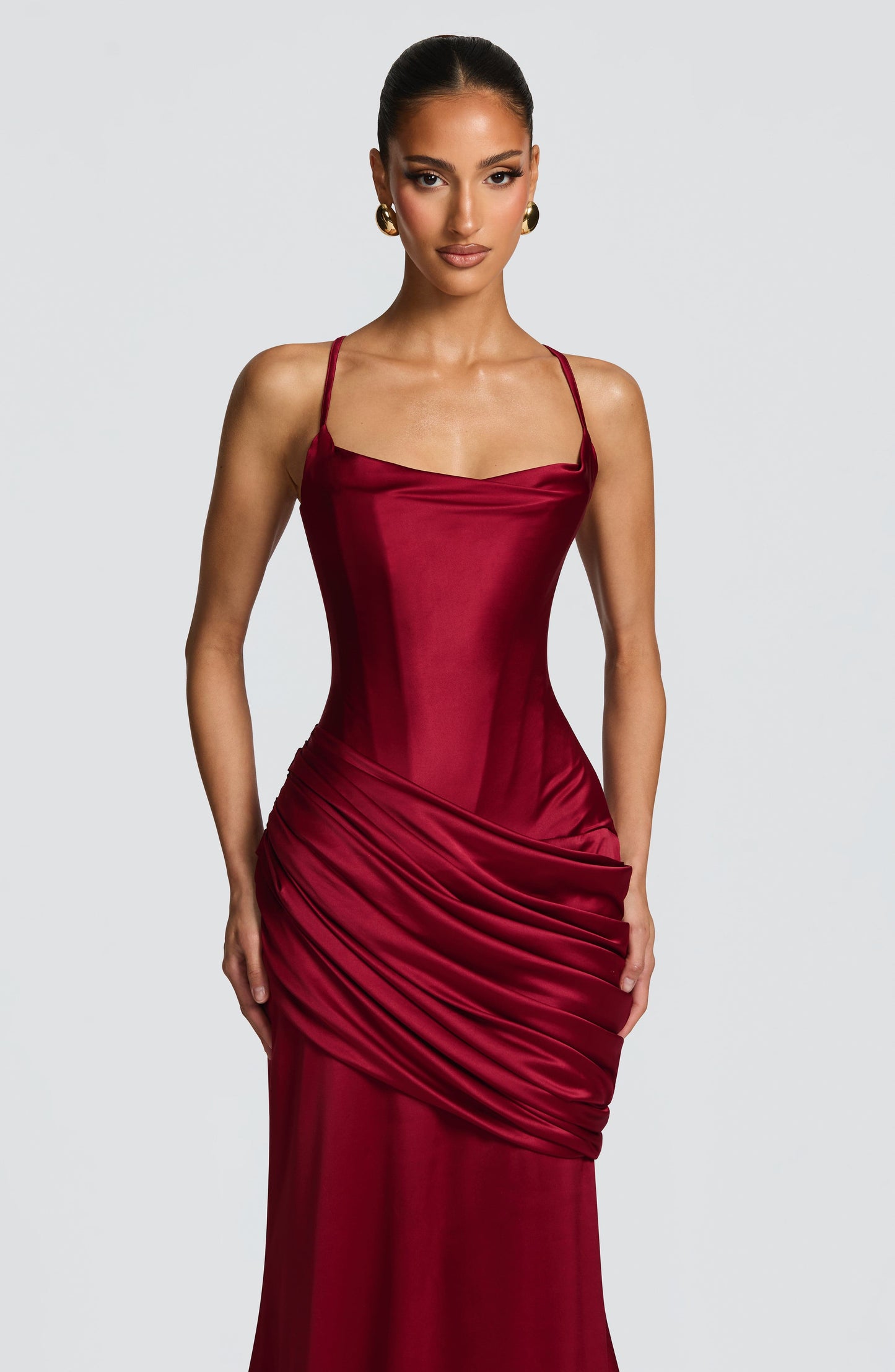 Close-up burgundy satin corset bodice with soft cowl neckline and thin shoulder straps