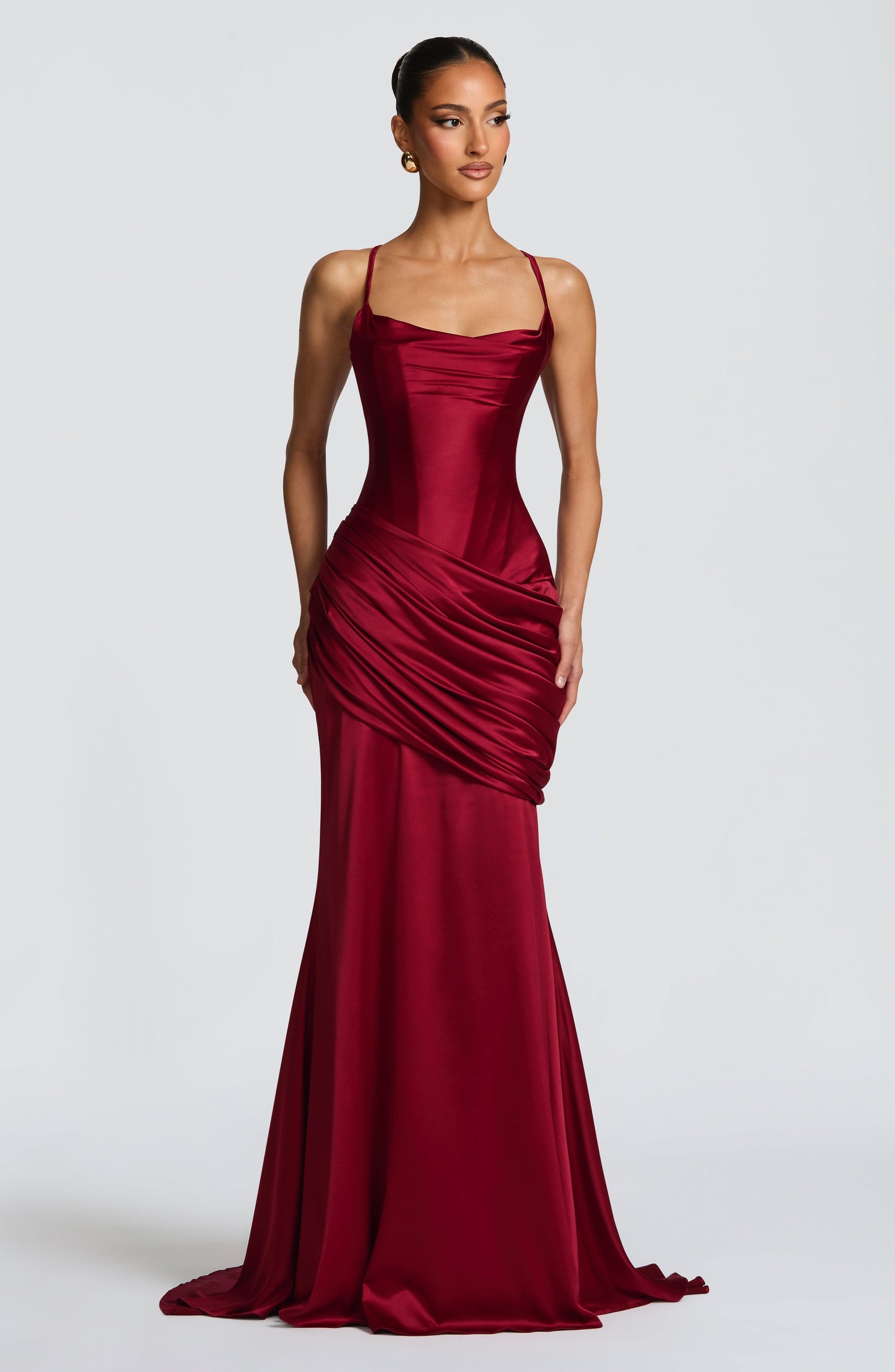 Burgundy satin corset maxi dress with spaghetti straps and draped skirt, wedding guest front view