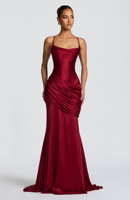 Burgundy satin corset maxi dress with spaghetti straps and draped skirt, wedding guest front view