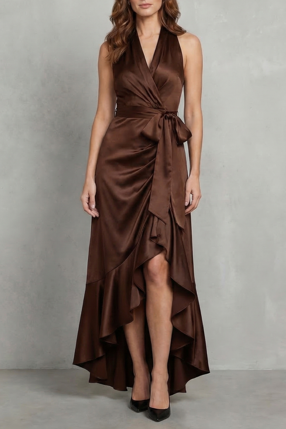 Front view of a rich brown satin halter wrap high-low maxi dress with a tied waist and ruffled skirt.