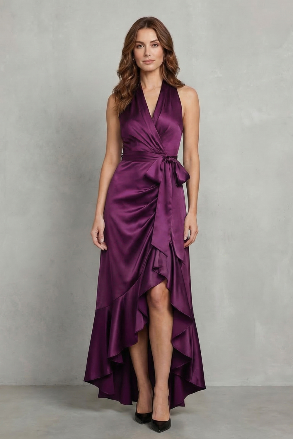 Women's elegant purple satin halter wrap high-low maxi dress, showcasing a flowing ruffled skirt and tied waist.