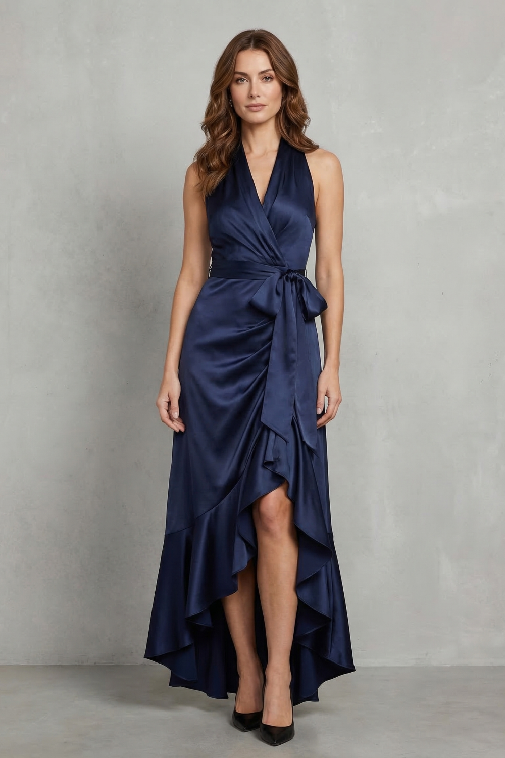 Full view of a navy blue satin halter wrap high-low maxi dress, perfect as a midi wedding guest dress.
