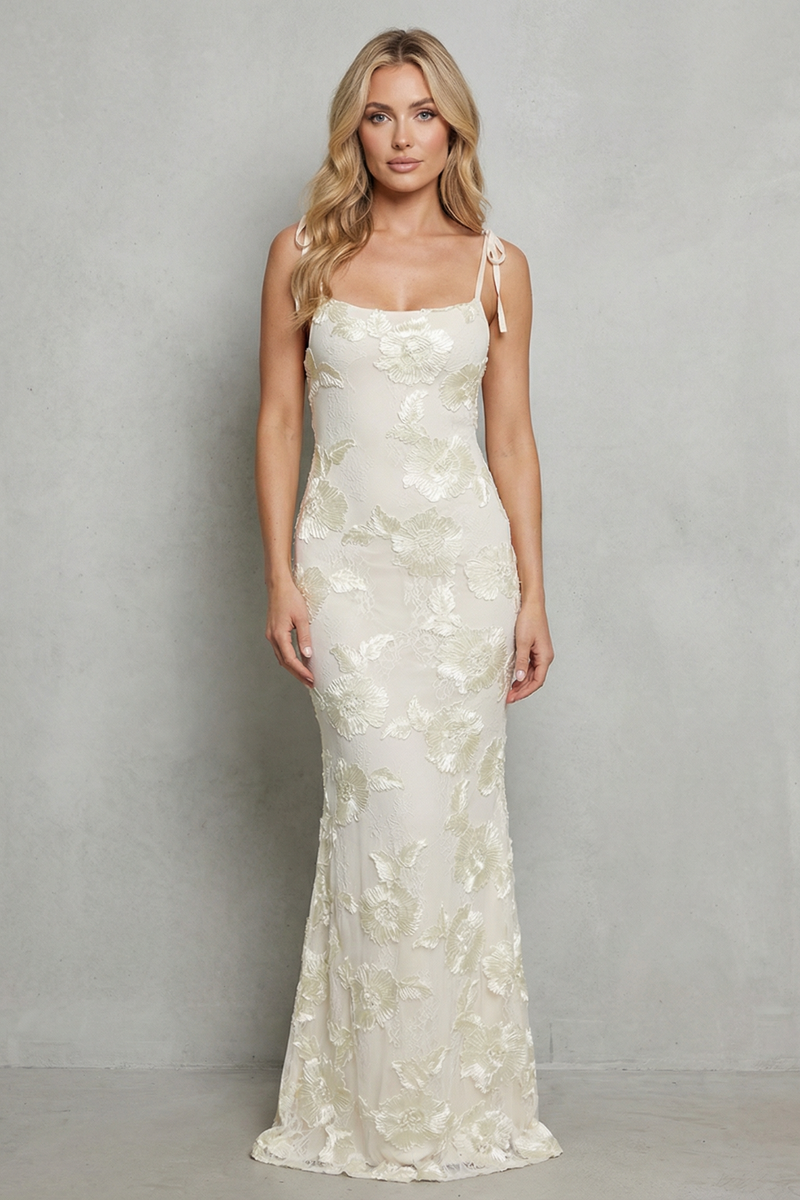 Front view of a beautiful white floral appliqué scoop neck maxi dress with tie-up shoulder straps, perfect for vacation.
