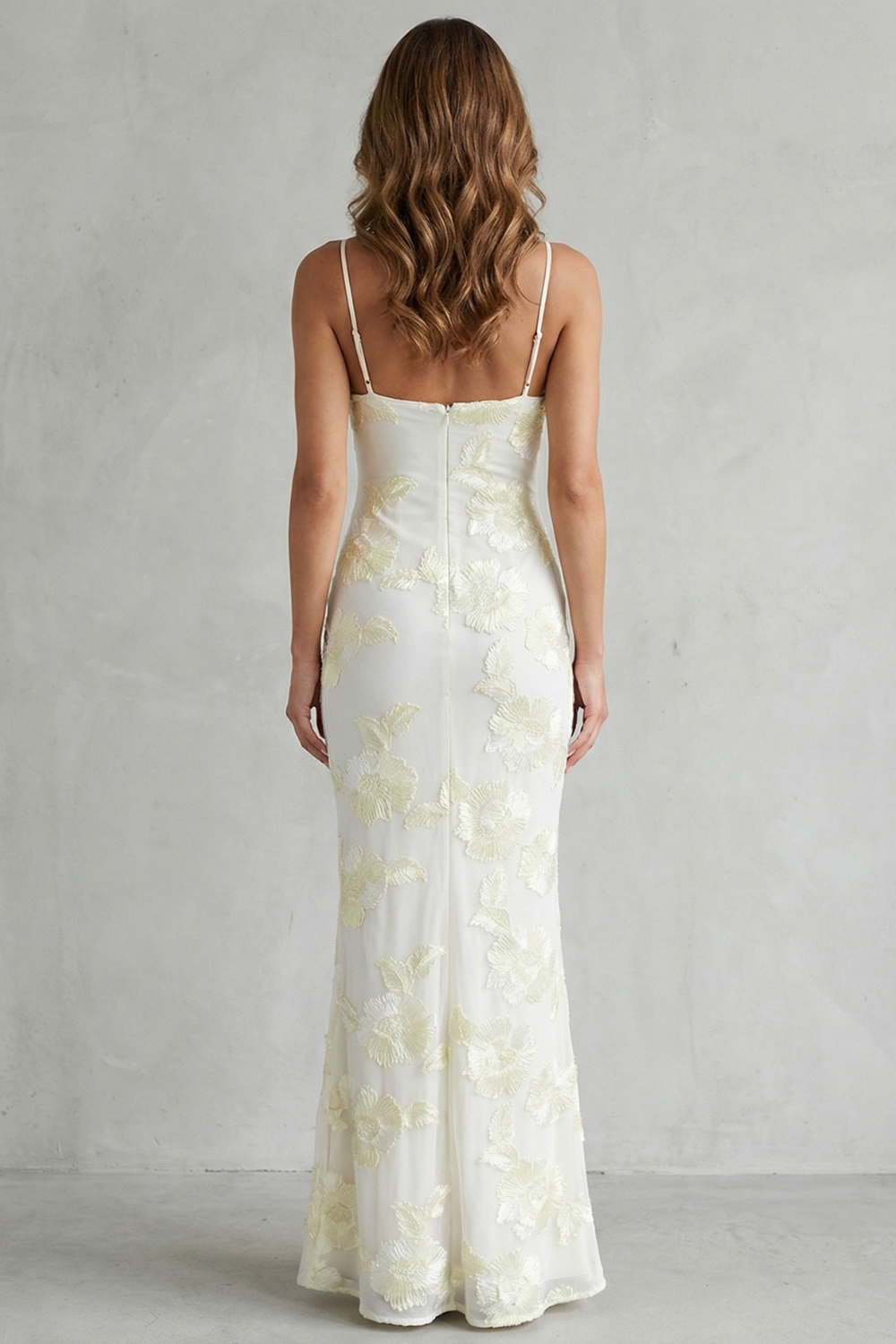 Back view of the white floral appliqué scoop neck maxi dress with thin straps, highlighting the elegant silhouette.