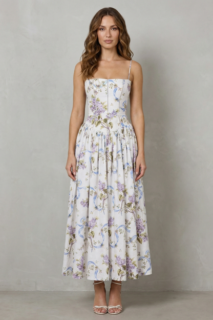 Front view of a women's floral midi dress with a structured corset bodice and thin straps, perfect for vacation outfits.