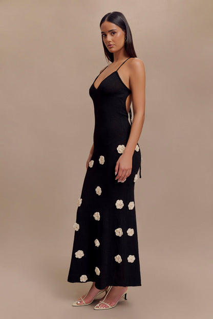 Side profile of black floral crochet v-neck maxi dress, showing flowy skirt and delicate details