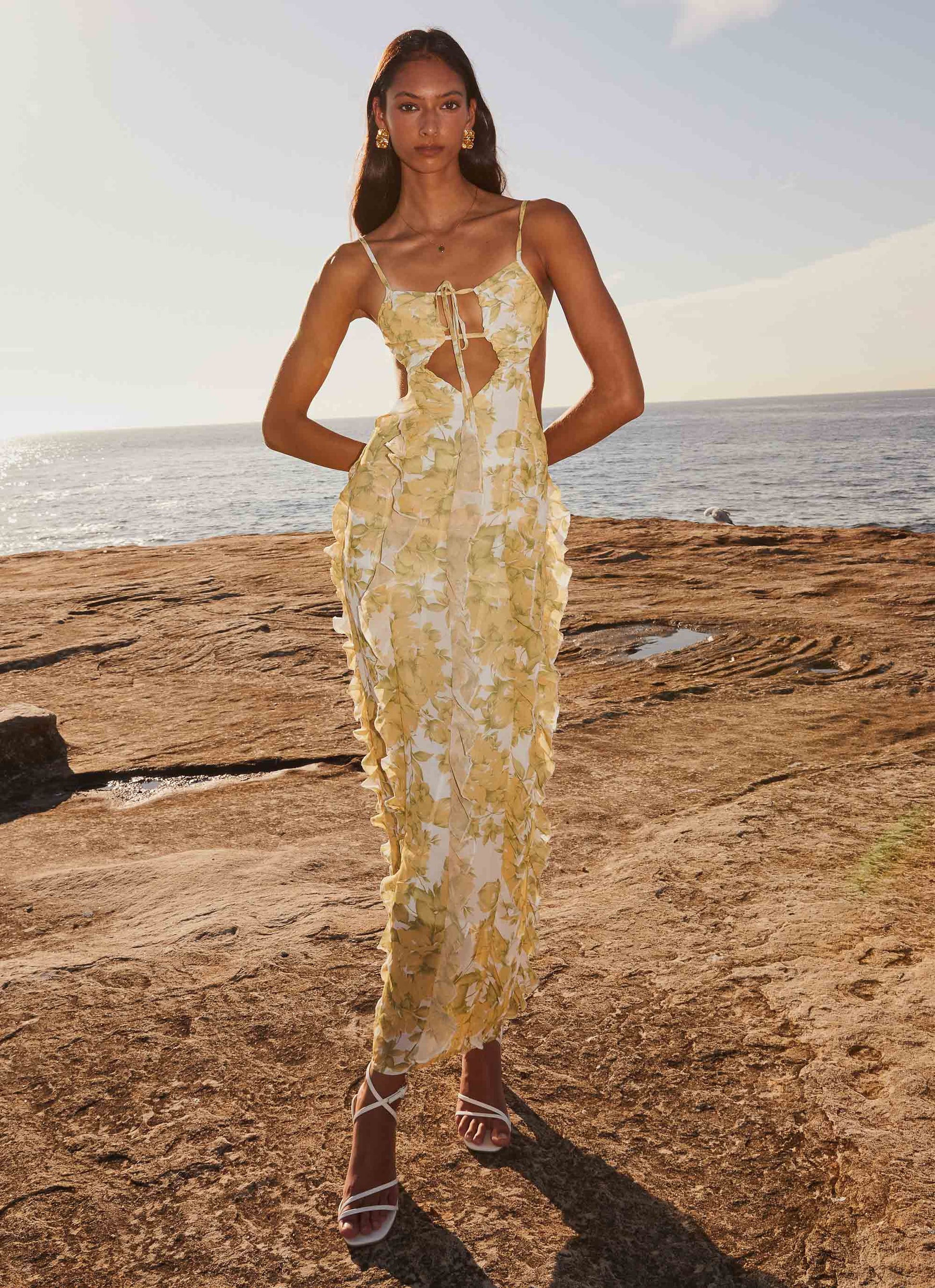 Front view of women's floral cut out ruffle tie front maxi dress with ruffled skirt detail, perfect for vacation outfits.