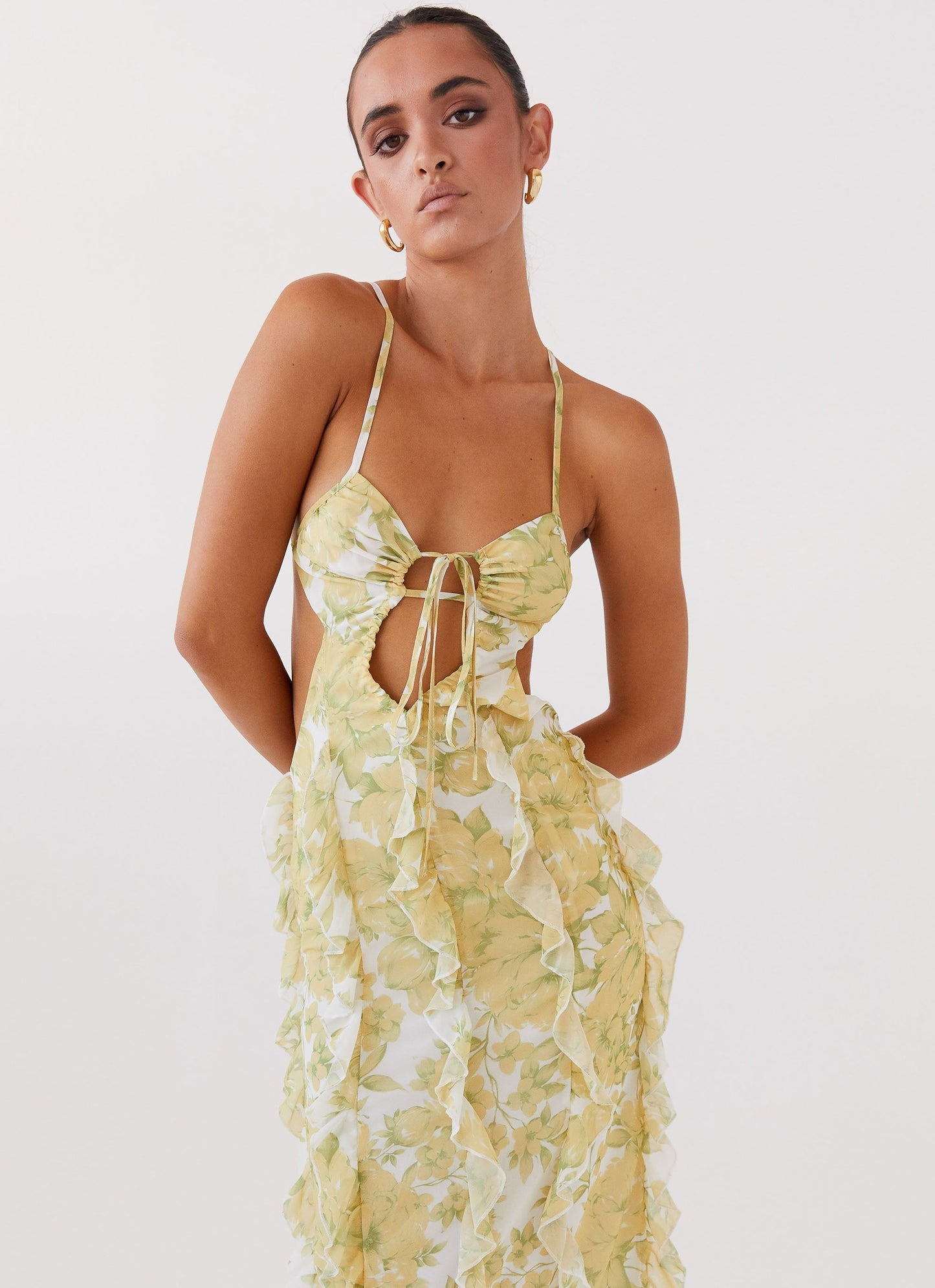 Close-up of the bodice of a women's floral cut out ruffle tie front maxi dress, showing the tie detail and floral pattern.