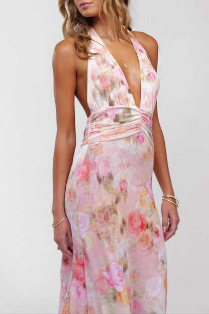 Close-up of the bodice on a women's pink floral halter maxi dress, showing the deep V-neck and ruched details.