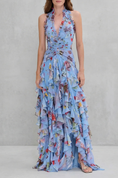 Light blue floral halter maxi dress with a deep V-neck and ruched bodice, featuring layered ruffles on the skirt.
