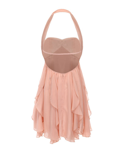 Back view of women's pink halter neck tiered mini dress, showing the open back, adjustable straps, and ruffled hem.