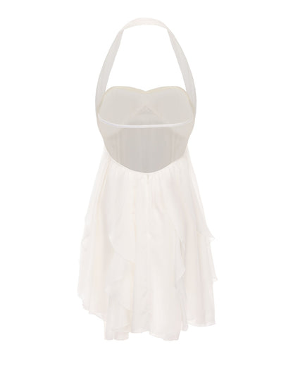 Back view of a white halter neck mini dress with an open back and ruffled tiered skirt detail.