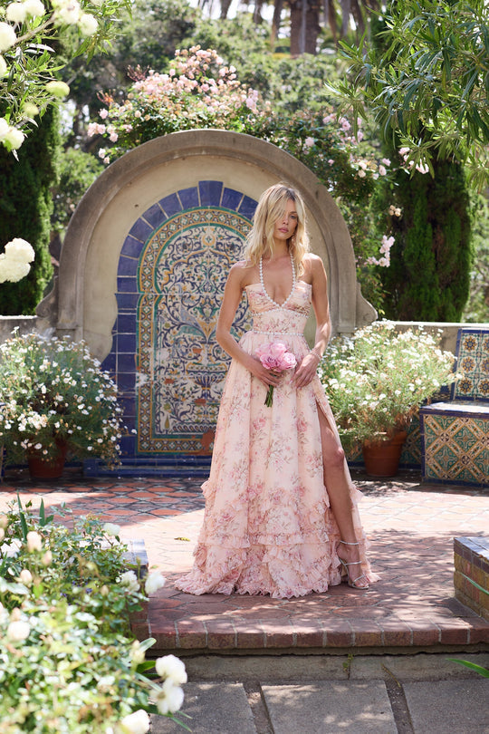 Peach floral halter maxi dress in garden scene, deep V bodice, high slit and cascading ruffle hem