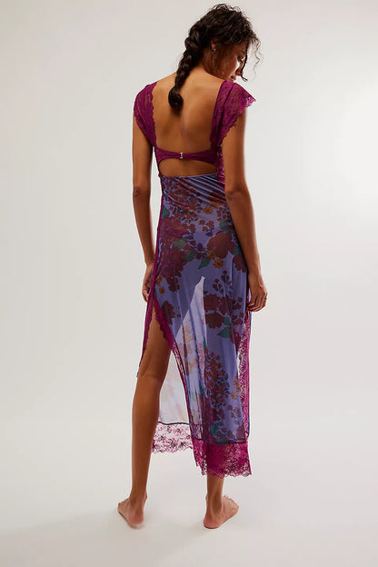Back view of a women's purple floral lace cut out back maxi dress, showcasing the open back and sheer skirt with a high slit.