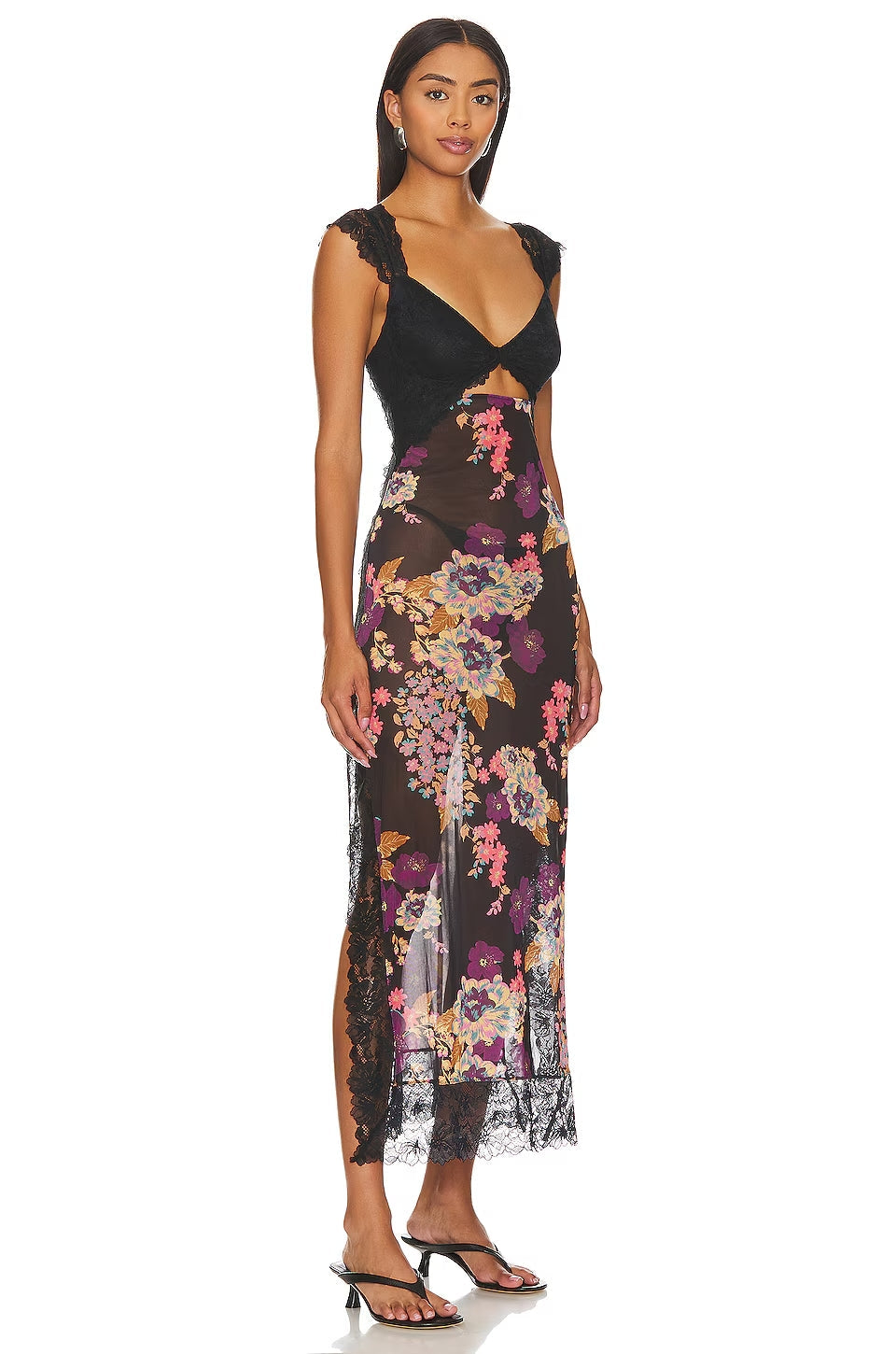 Side view of a women's black floral lace cut out back maxi dress, highlighting the sheer fabric, lace trim, and vibrant floral design.