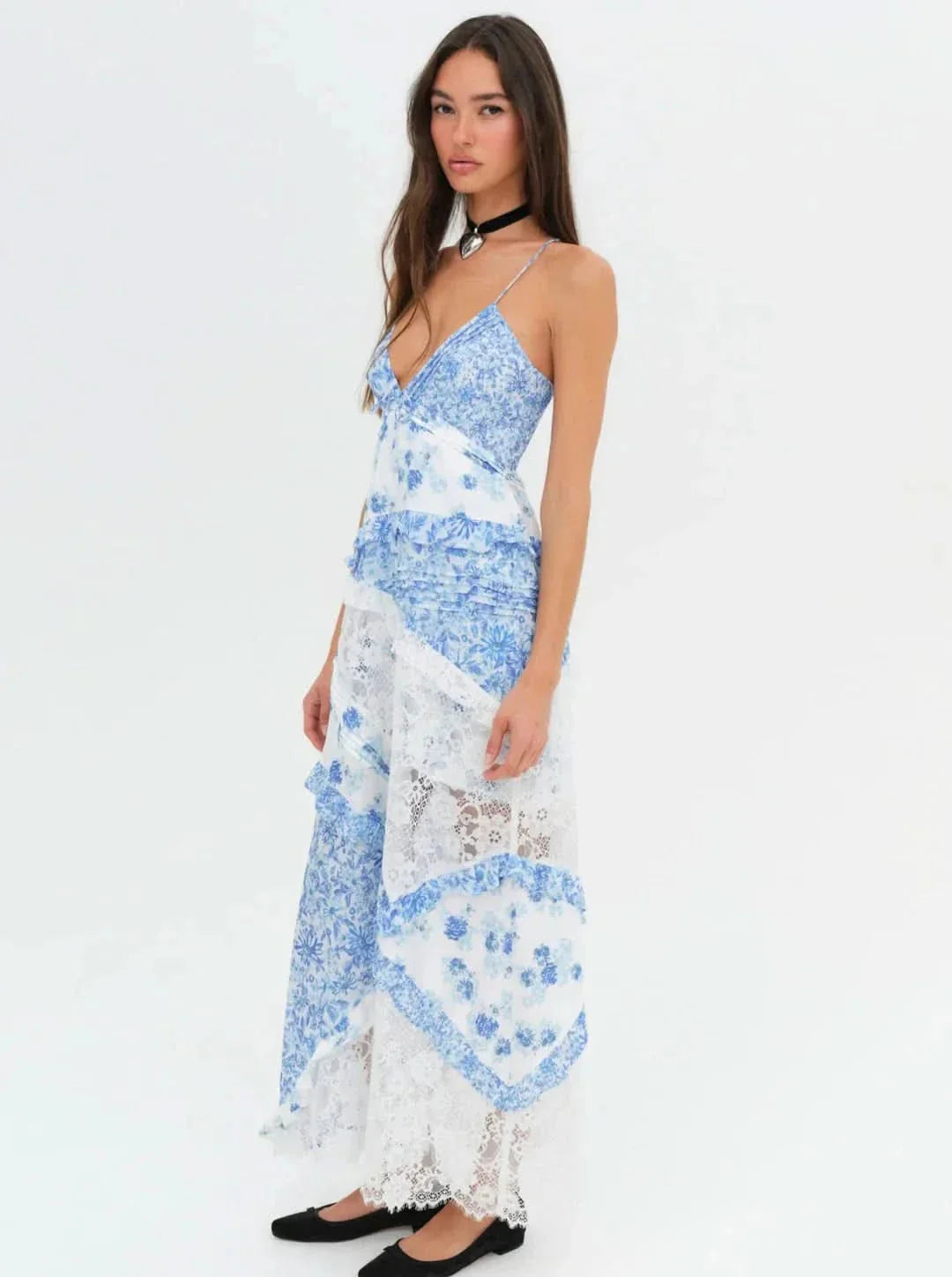 Side view of women's blue and white floral V-neck maxi dress with lace and ruffled skirt